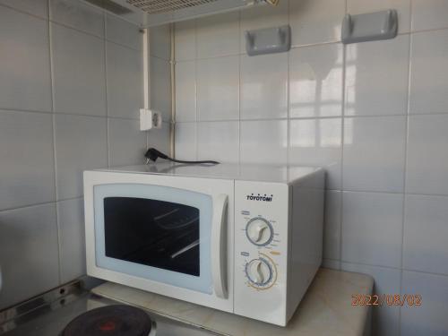 a microwave oven sitting on top of a counter at Dimi's studio in Skala Kallonis