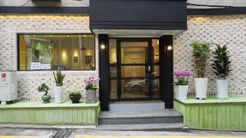a store front with potted plants on display at Myeongdong Guesthouse Como in Seoul