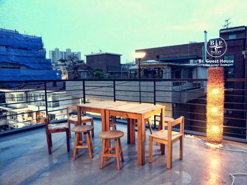 a wooden table and chairs on top of a roof at Br. Guesthouse Hongdae in Seoul