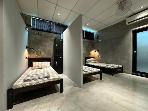 a room with two beds and a window at M-Stay Hostel in Chemor
