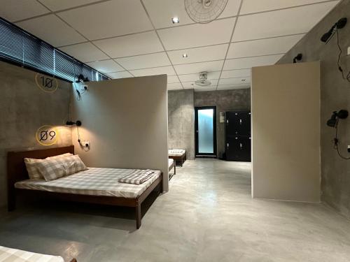 a room with a couch and a bed in it at M-Stay Hostel in Chemor