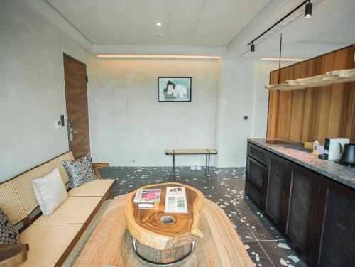 a living room with a coffee table in the middle at The Forest Museum in Zhuolan