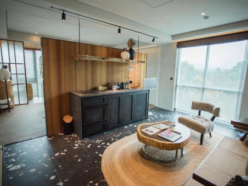 a living room with a coffee table and a couch at The Forest Museum in Zhuolan