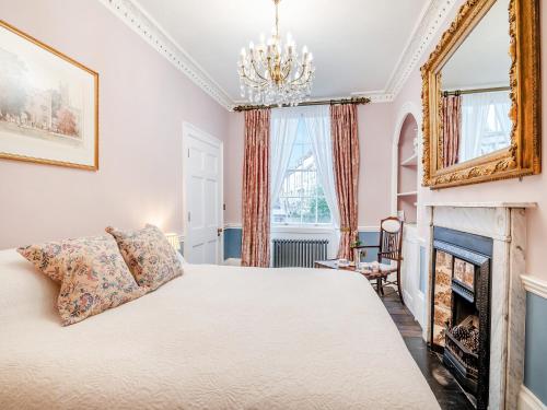 a bedroom with a bed and a fireplace at Rock House in Wells