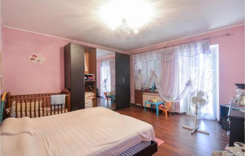 a bedroom with a bed and a room with a fan at Awesome Home In Camino Monferrato With Kitchen in Camino