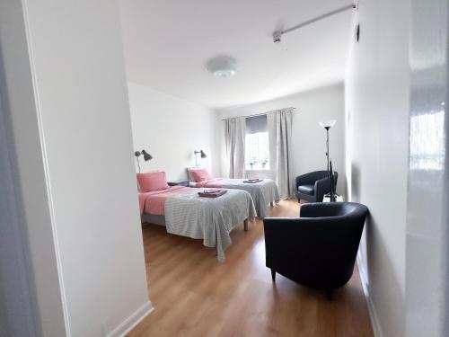 a bedroom with a bed and a table and a chair at Strandgården Karlstad in Karlstad