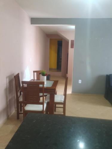 a dining room with a table and chairs at Casa temporada da Nenê in Ipitangas