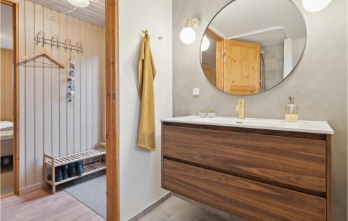 a bathroom with a sink and a mirror at Amazing Home In Ebeltoft With Wifi in Ebeltoft