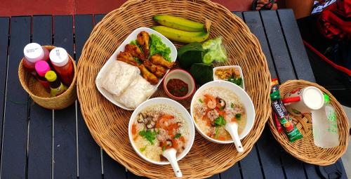 a basket of food with bowls of food on a table at หัวน้ำฮิลล์huanamhill in Pua