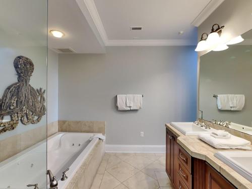 a bathroom with a tub and a sink and a shower at Adagio 105B in Santa Rosa Beach