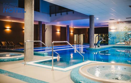 a pool in a hotel with two hot tubs at WR SPORT HOTEL & SPA - Centrum Sportu i Rozrywki in Rzeszów