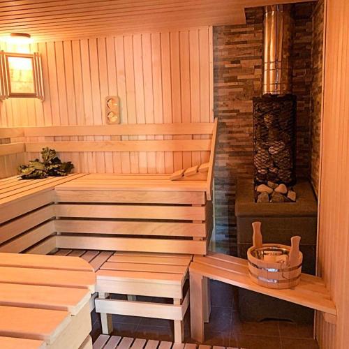 a wooden sauna with a bench and a heater at Casa Navajas in Jérica