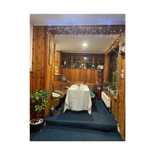 a room with a table with a white table cloth at Pensiunea Nick in Sinaia