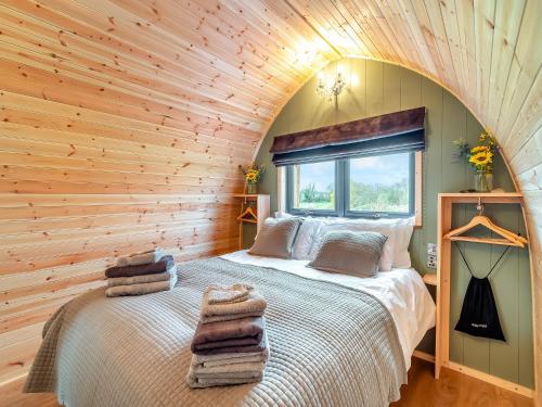 a bedroom with a bed in a wooden wall at The Hive - Uk45565 in Longford