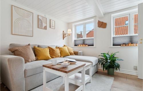 a living room with a couch and a table at Pet Friendly Home In Rønne With Kitchen in Rønne
