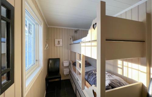a small bedroom with a bunk bed and a window at 5 Bedroom Gorgeous Home In Rn in Ron