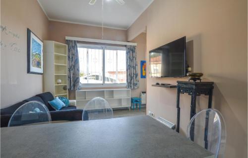 a living room with a table and a couch and a television at Stunning Apartment In Varazze With Wifi in Varazze