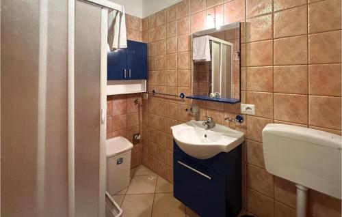 a small bathroom with a sink and a toilet at 2 Bedroom Nice Apartment In Lecce Nei Marsi in Gioia dei Marsi