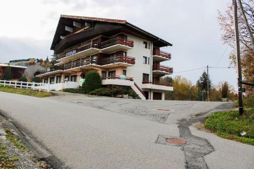 a large apartment building on the side of a road at T1 Cosy Pleine station de ski in Bellevaux