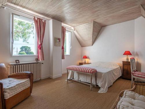 une chambre avec un lit, un canapé et une fenêtre dans l'établissement Villa néo-bretonne 5p, 120m², 8 pers, à 600m de la plage, jardin, Wifi, animaux acceptés, 3* - FR-1-477-6, à La Trinité-sur-Mer
