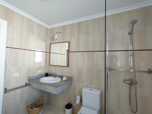 a bathroom with a sink and a shower and a toilet at Villa Rubicón Costa in Playa Blanca