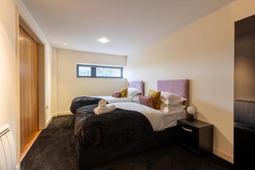 a bedroom with two beds and a window at Durham City Luxury Apartment in Durham