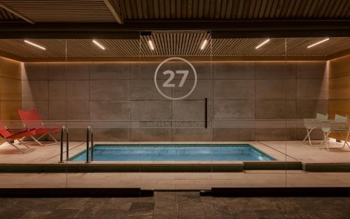 a swimming pool with a sign on a wall at Kamieniec 27 Bed & Breakfast in Zakopane