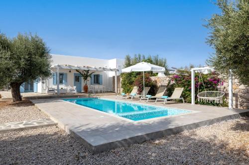 a swimming pool in front of a house at Kalathos Dream Villas in Kalathos