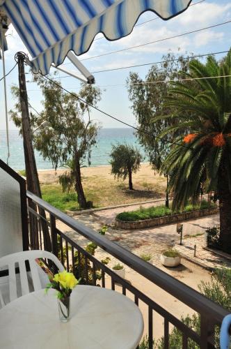 a balcony with a table and a view of the ocean at Seaside Studios in Paralia Dionysiou