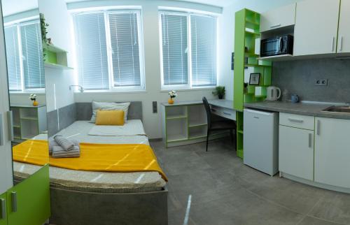 a small room with a bed and a desk at DORM BG pet-friendly Aparthotel in Stara Zagora