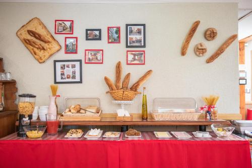 a table with a red table cloth and some food at Hotel Di Torlaschi in Valdivia