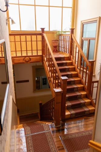 a wooden staircase in a house with a large window at Hotel Di Torlaschi in Valdivia