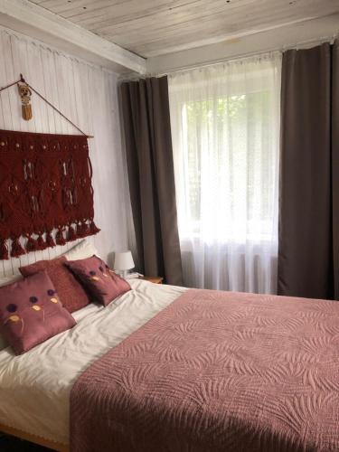 a bedroom with a large bed and a window at Domek w Glince in Ujsoły