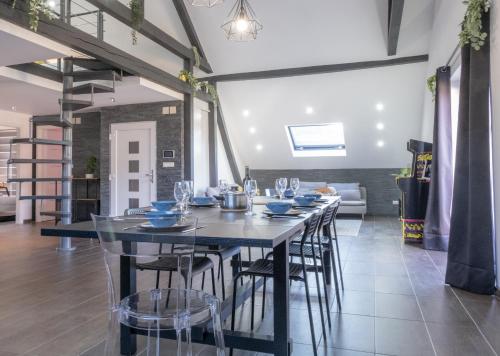 a dining room with a long table and chairs at Nouveau - Le Funtastic - Europa Park Rulantica in Huttenheim