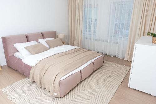 a large bed in a room with a large window at Apartament Węglowa 21 in Żywiec