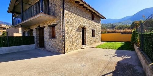 a large brick building with a fence next to it at CASA COTIELLA RAÑIN in Rañín