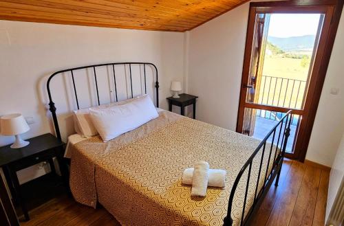 a bedroom with a bed with two towels on it at CASA COTIELLA RAÑIN in Rañín