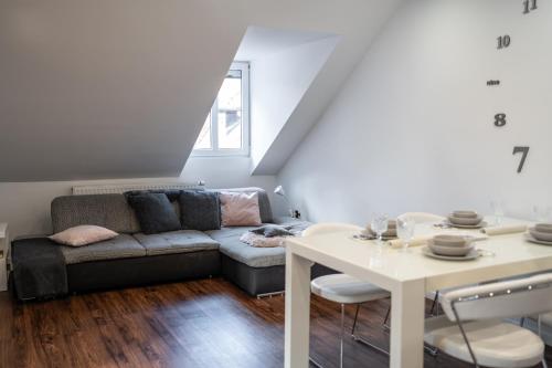 a living room with a couch and a table at Celje Center Apartment in Celje