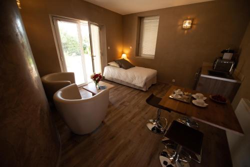 a bathroom with a tub and a bed in a room at Résidence hôtelière et SPA des sources du gros noyer in Malaucène