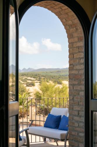a chair on a balcony with a view of the desert at Hotel Le Dune Piscinas in Ingurtosu