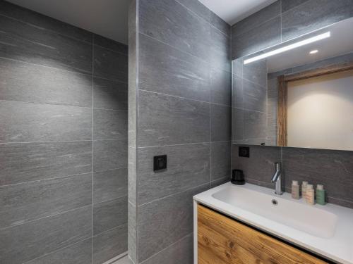 une salle de bain avec un lavabo et un miroir dans l'établissement Chalet à Megève avec Wellness: 6 adultes, 4 enfants, ascenseur, terrasse, cheminée, accès sauna/piscine - FR-1-569-56, à Megève