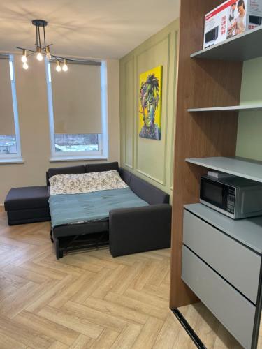 a bedroom with a bed and a microwave in it at Airport Apartment 14 Self Check-In Free parking in Vilnius