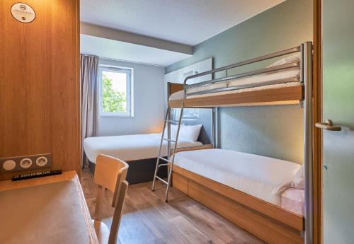 a bunk bed room with two bunk beds and a ladder at B&B HOTEL Caen Mémorial in Caen