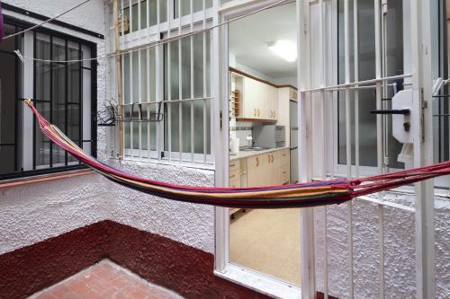 a hammock in a room in a building at Senda el Cantal 3habitaciones Beach in Cala del Moral