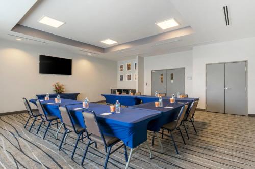 a conference room with blue tables and chairs at Comfort Inn & Suites Port Charlotte-Punta Gorda in Port Charlotte