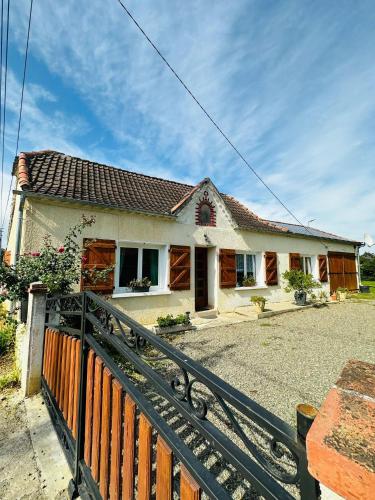 a house with a fence in front of it at Gîte du Lavoir in Moncaup