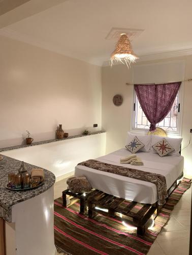a bedroom with a large bed and a window at CHILL SURFER HOSTEL in Tamraght Ouzdar
