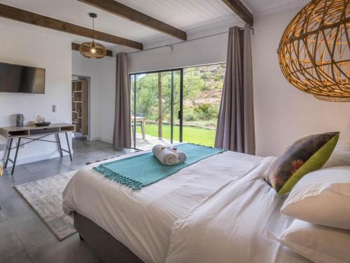 a bedroom with a bed with a towel on it at Ludicks Farm in Montagu