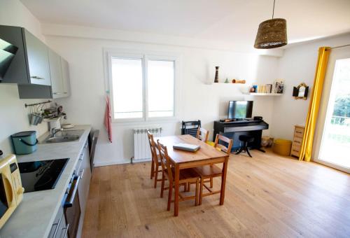a kitchen with a table and chairs in a room at Maison avec piscine entre garrigue et Cévennes in Cazilhac