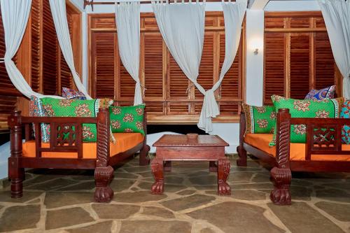 a living room with two chairs and a table at Beach Way Villa in Malindi